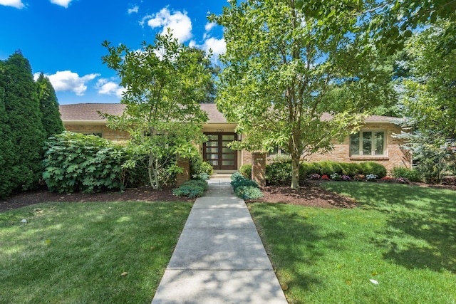 2790 Alliston Ct, Columbus, OH 43220 - obstructed view of property with french doors, a front yard, brick siding, and roof with shingles