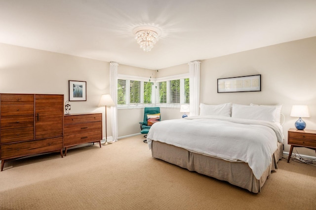 2790 Alliston Ct, Columbus, OH 43220 - bedroom featuring light colored carpet, a chandelier, and baseboards