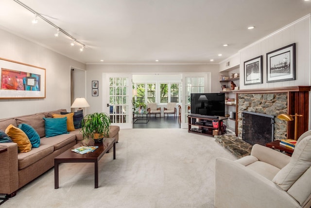 2790 Alliston Ct, Columbus, OH 43220 - living area featuring ornamental molding, rail lighting, a stone fireplace, recessed lighting, and carpet