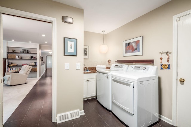 2790 Alliston Ct, Columbus, OH 43220 - laundry room featuring independent washer and dryer, cabinet space, baseboards, and dark tile patterned flooring