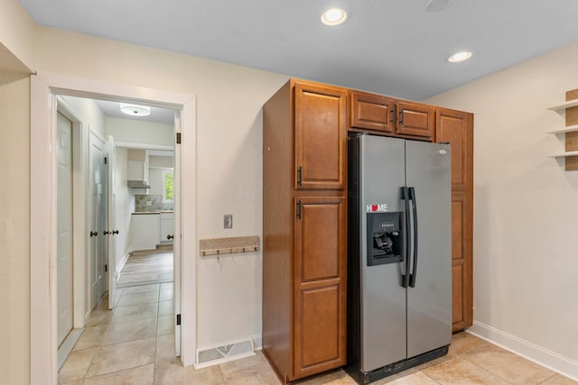 52 Hayes Dr, Delaware, OH 43015 - kitchen featuring stainless steel fridge, baseboards, brown cabinets, light tile patterned floors, and recessed lighting