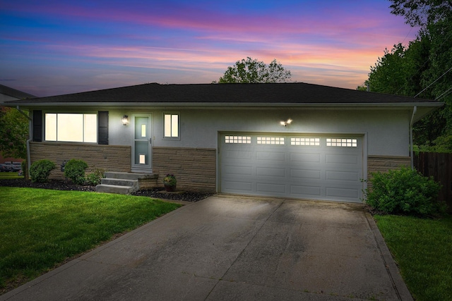 52 Hayes Dr, Delaware, OH 43015 - ranch-style home with stone siding, driveway, a garage, and stucco siding