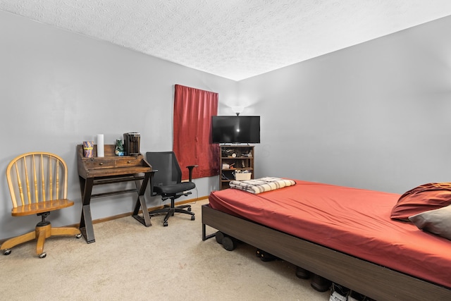 carpeted bedroom with a textured ceiling and baseboards
