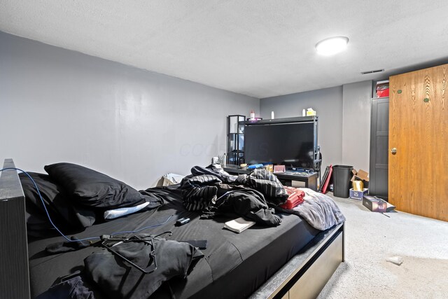 bedroom with carpet and a textured ceiling
