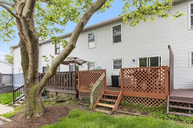 rear view of property featuring a deck