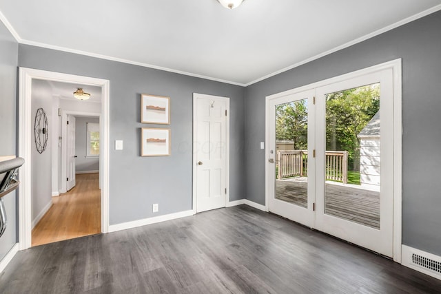 unfurnished bedroom featuring multiple windows, dark wood-type flooring, access to outside, baseboards, and ornamental molding