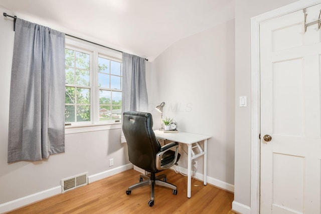 office featuring wood finished floors, baseboards, and lofted ceiling