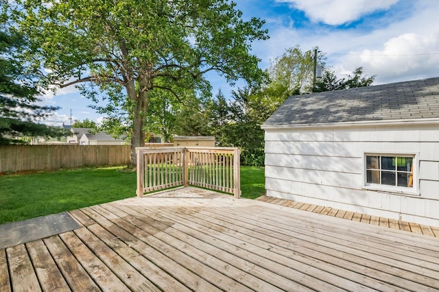 wooden deck with a storage shed and an outdoor structure