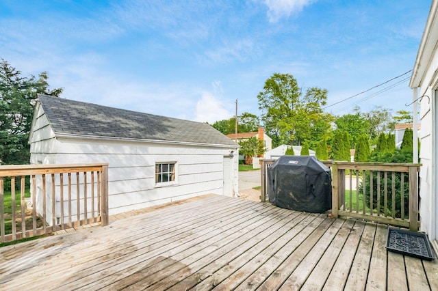 wooden deck featuring a grill