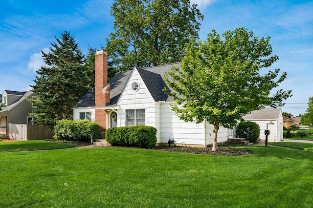 view of front facade featuring a chimney and a shingled roof