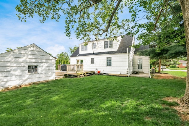back of house featuring a wooden deck, a yard, roof with shingles, and central air condition unit