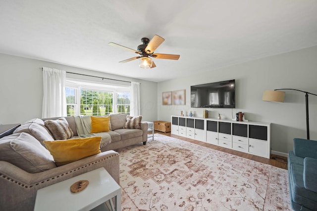 living area with wood finished floors and ceiling fan