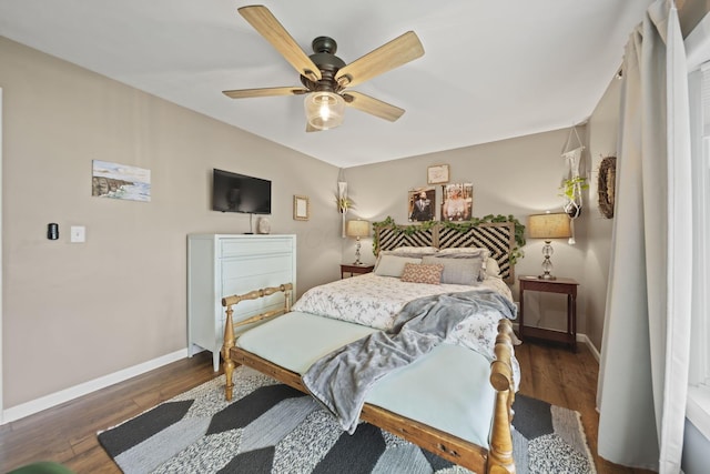 bedroom featuring baseboards, wood finished floors, and ceiling fan