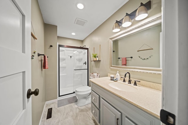 full bathroom featuring a stall shower, toilet, vanity, marble finish flooring, and recessed lighting