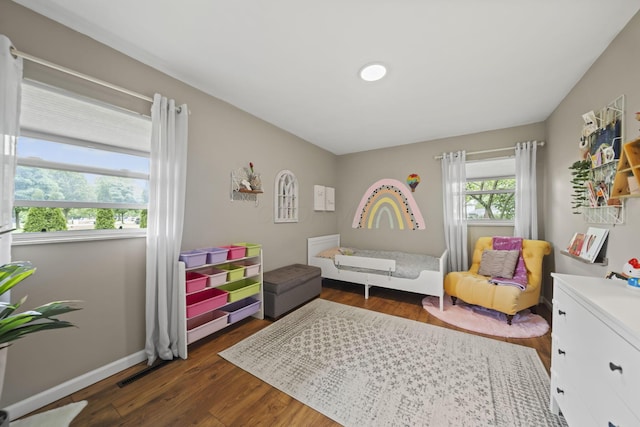 rec room with dark wood-style flooring and baseboards