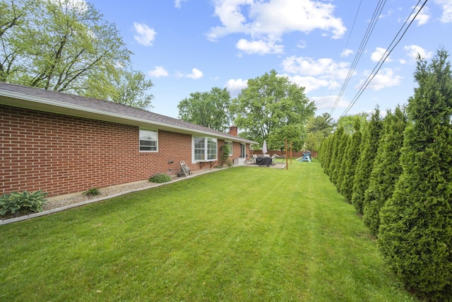 view of grassy yard with a patio