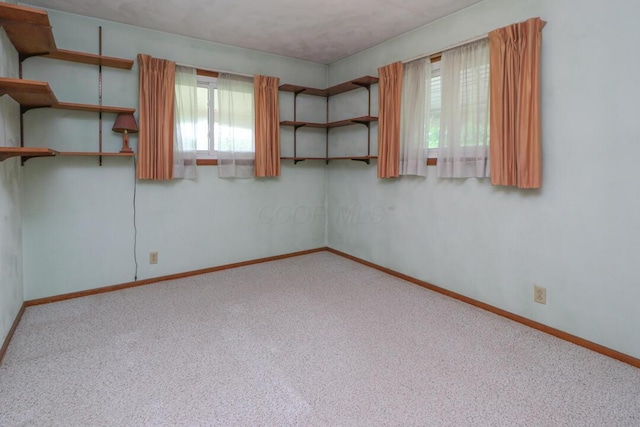 1294 Kings Corners Rd E, Mansfield, OH 44904 - unfurnished room with plenty of natural light, baseboards, and carpet flooring