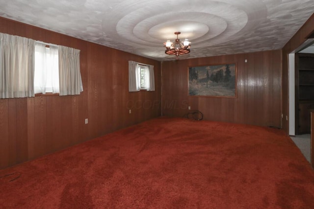 1294 Kings Corners Rd E, Mansfield, OH 44904 - carpeted spare room with a chandelier and wooden walls