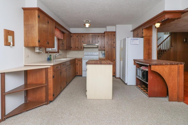 1294 Kings Corners Rd E, Mansfield, OH 44904 - kitchen featuring white appliances, under cabinet range hood, a sink, backsplash, and a center island