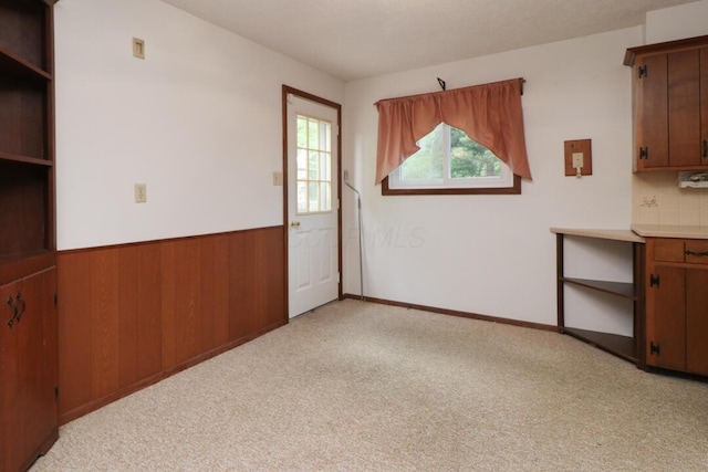 1294 Kings Corners Rd E, Mansfield, OH 44904 - unfurnished dining area with light carpet and wainscoting