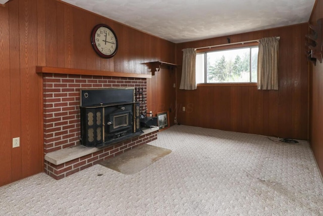 1294 Kings Corners Rd E, Mansfield, OH 44904 - unfurnished living room featuring a wood stove, wood walls, and carpet