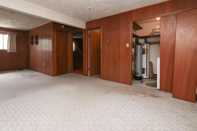 1294 Kings Corners Rd E, Mansfield, OH 44904 - spare room with wooden walls, water heater, and carpet floors