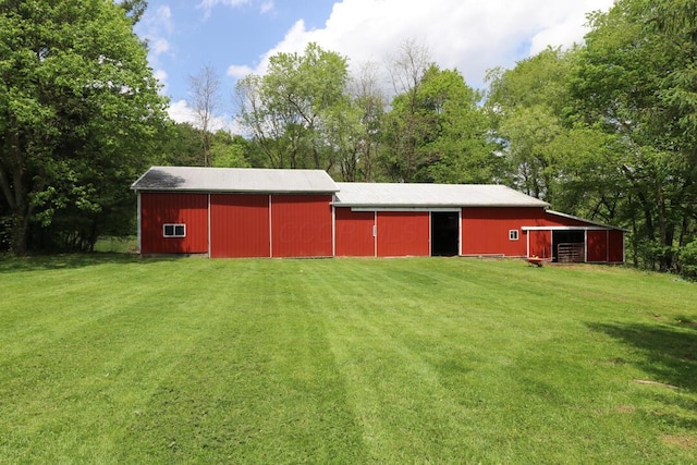 1294 Kings Corners Rd E, Mansfield, OH 44904 - view of green lawn featuring a pole building, an outbuilding, and a detached garage
