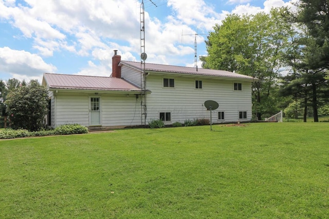 1294 Kings Corners Rd E, Mansfield, OH 44904 - back of property with a lawn, a chimney, and metal roof