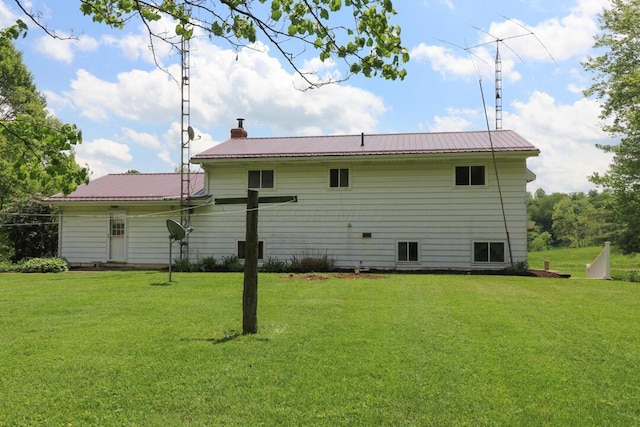 1294 Kings Corners Rd E, Mansfield, OH 44904 - back of house featuring a lawn, metal roof, and a chimney