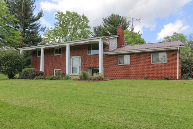 1294 Kings Corners Rd E, Mansfield, OH 44904 - back of house featuring brick siding, a lawn, and a chimney