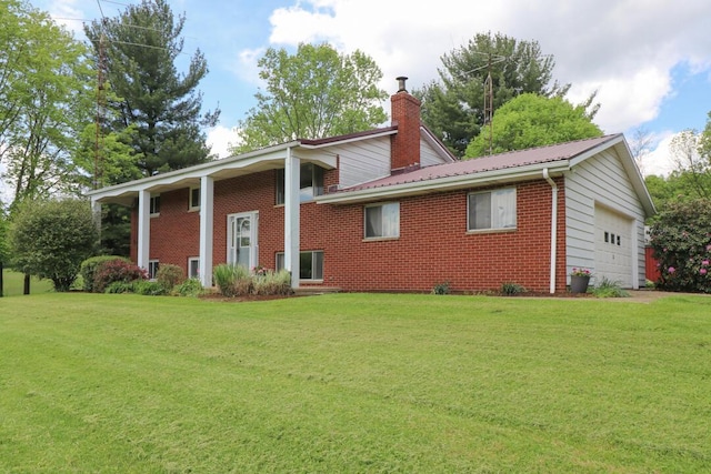 1294 Kings Corners Rd E, Mansfield, OH 44904 - back of house featuring brick siding, a chimney, a lawn, and metal roof