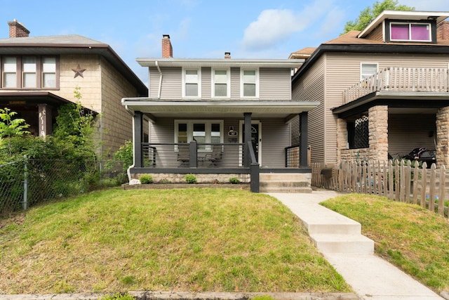 american foursquare style home with a porch and a chimney