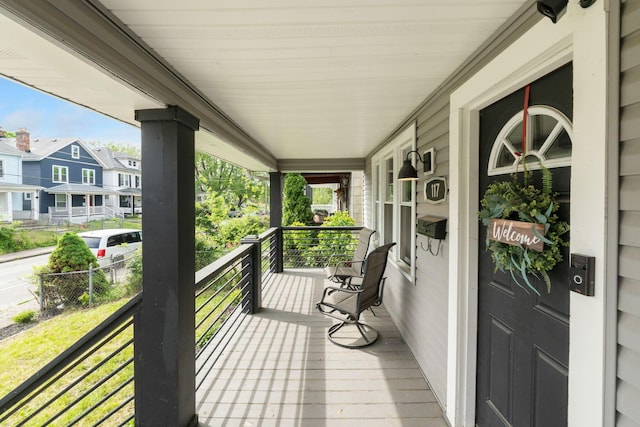 balcony featuring a porch and a residential view