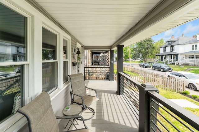 deck featuring a porch and a residential view