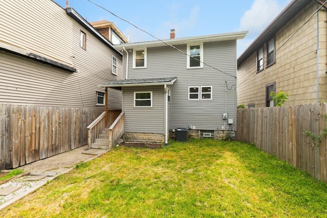 rear view of property with a chimney and central AC unit