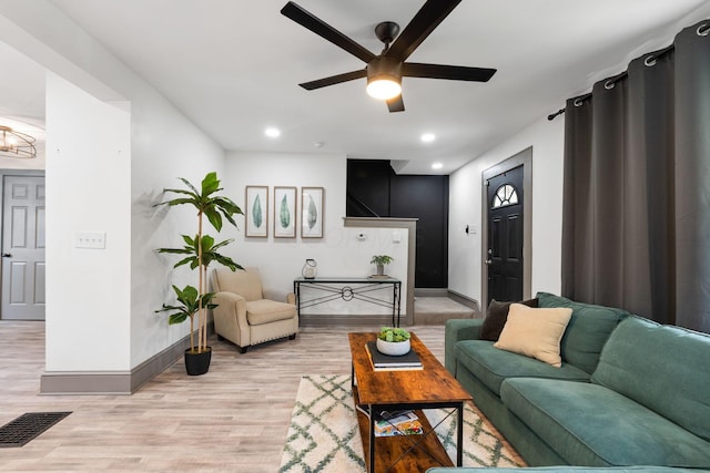 living room featuring baseboards, a ceiling fan, light wood-type flooring, and recessed lighting