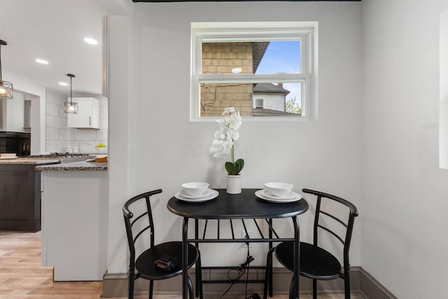 dining room with light wood-type flooring and recessed lighting