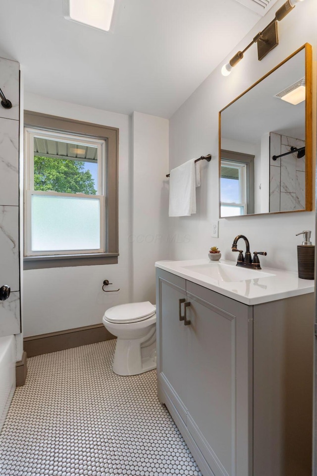 bathroom featuring vanity, toilet, and shower / washtub combination