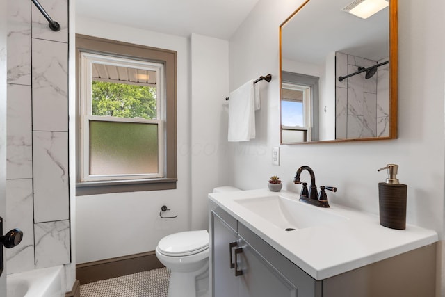 bathroom with toilet, vanity, and washtub / shower combination