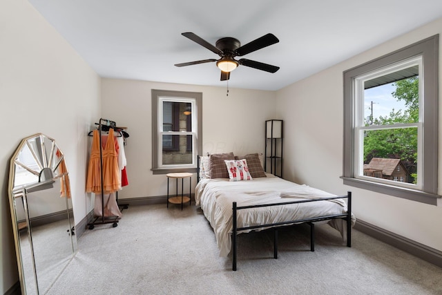 carpeted bedroom with baseboards and a ceiling fan