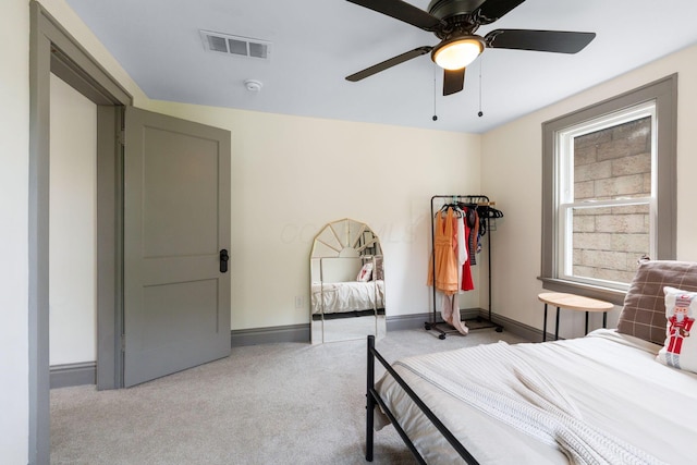 bedroom with light carpet, baseboards, and a ceiling fan