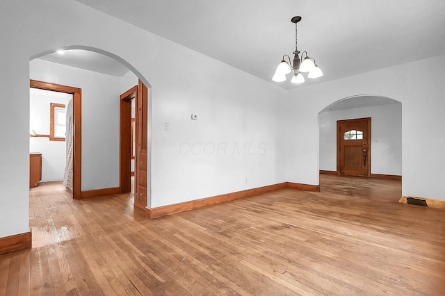 253 Robbins Dr, Newark, OH 43055 - unfurnished dining area featuring light wood-type flooring, baseboards, a chandelier, and plenty of natural light
