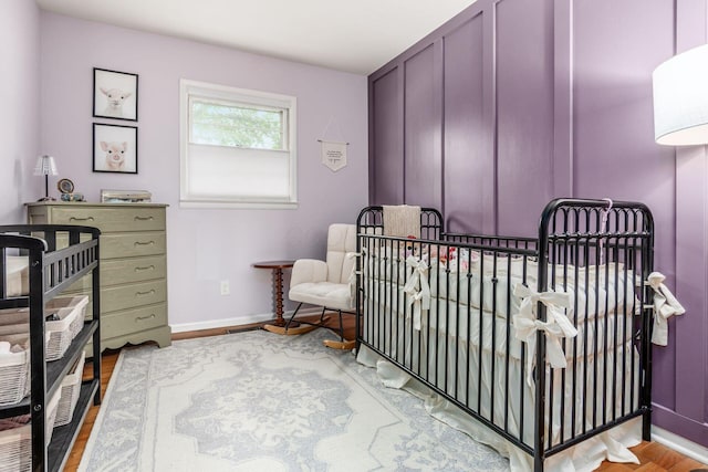 363 Cheyenne Dr, Westerville, OH 43081 - bedroom featuring wood finished floors, a nursery area, and baseboards