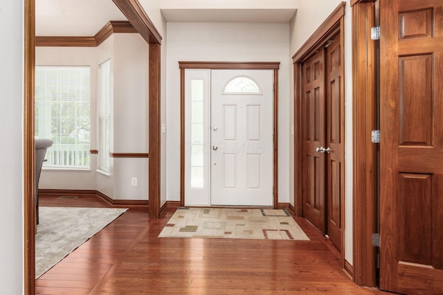 6923 Bishops Crossing Cir, Dublin, OH 43016 - entryway featuring wood-type flooring and ornamental molding