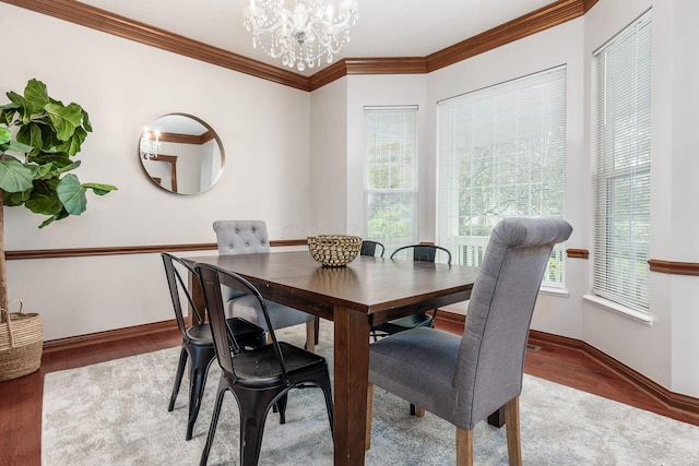 6923 Bishops Crossing Cir, Dublin, OH 43016 - dining room with wood finished floors, a chandelier, and crown molding