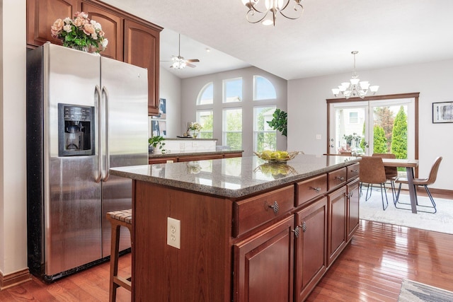 6923 Bishops Crossing Cir, Dublin, OH 43016 - kitchen with stainless steel refrigerator with ice dispenser, a chandelier, a center island, light wood finished floors, and pendant lighting