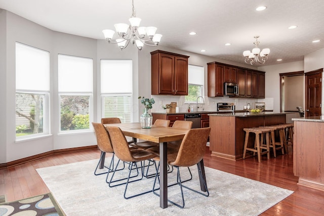 6923 Bishops Crossing Cir, Dublin, OH 43016 - dining room featuring a chandelier, healthy amount of natural light, hardwood / wood-style flooring, and recessed lighting