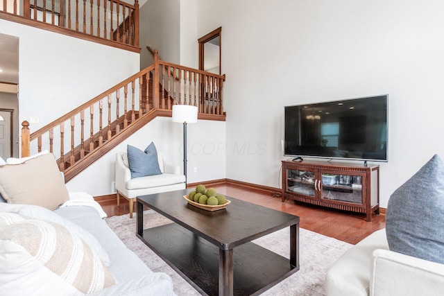 6923 Bishops Crossing Cir, Dublin, OH 43016 - living area with a towering ceiling, stairway, and wood finished floors