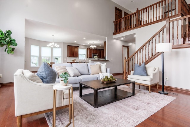 6923 Bishops Crossing Cir, Dublin, OH 43016 - living area with a chandelier, hardwood / wood-style flooring, stairway, and a towering ceiling
