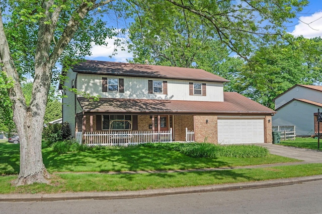 6329 Birkewood St, Columbus, OH 43229 - traditional home with covered porch, driveway, an attached garage, a front yard, and brick siding